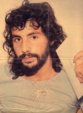 Cat Stevens holding an envelope addressed to 'Cat Stevens'